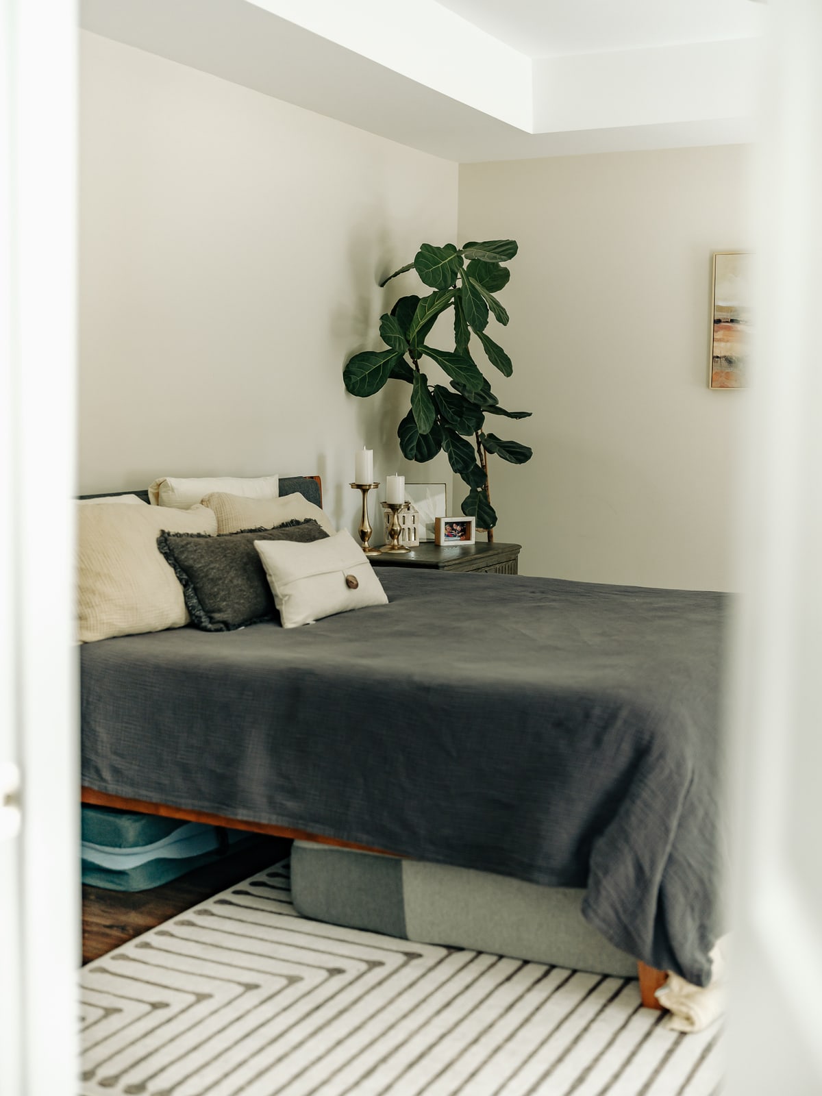 A freshly made bed and neatly finished bedroom after cleaning